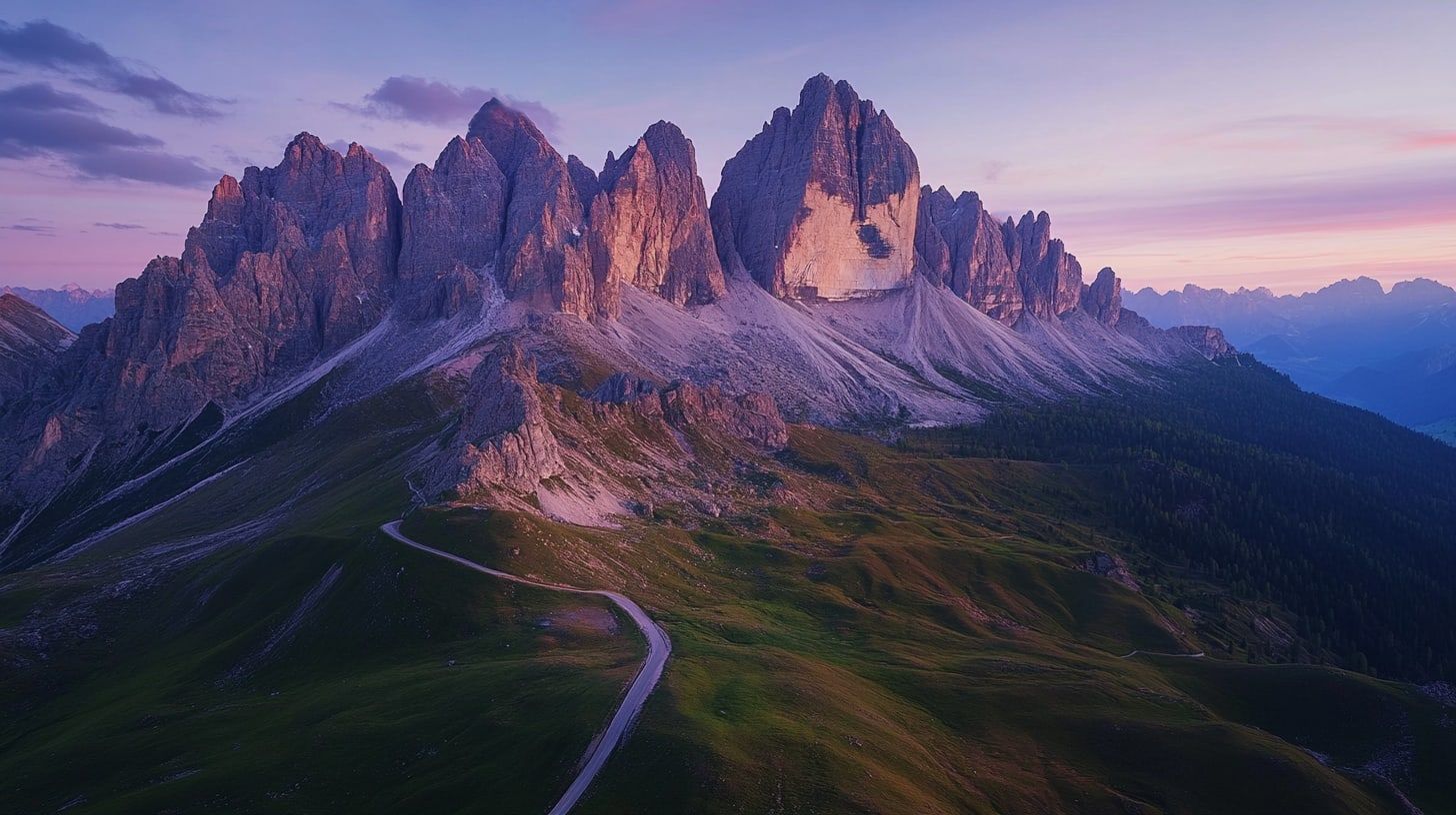 Aerial dusk view of the Dolomite rock towers with a mountain road winding through green valleys (illustrative)